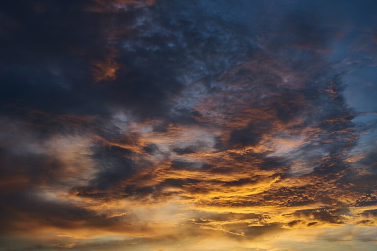 Background of vivid light of sunset with the dark cloud